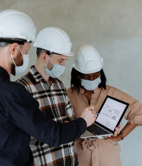 Professional architects reviewing construction blueprints in magazine editorial style